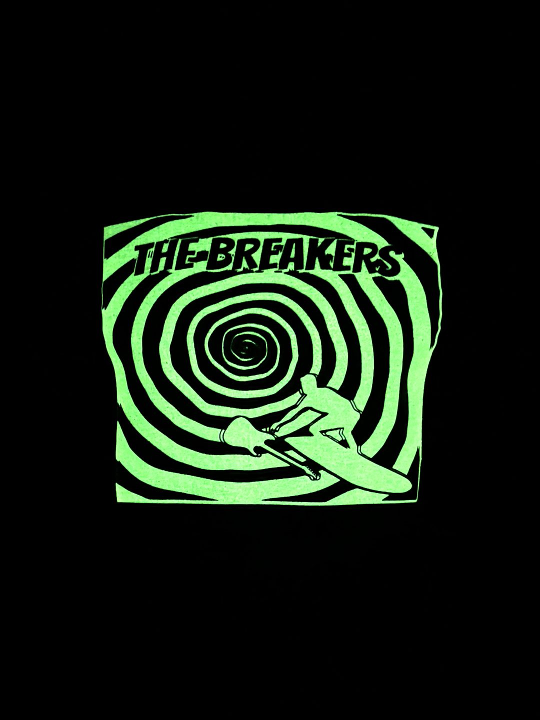 The Breakers shirt glowing green in a completely dark room